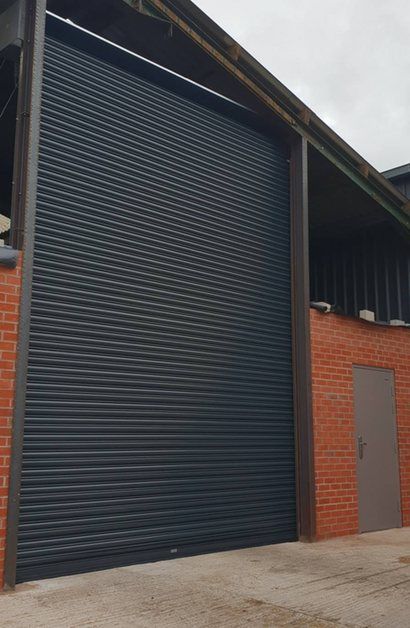 Roller shutter in Gray with steel security side door Crewe